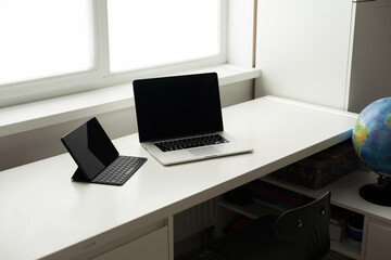 laptop and tablet on a white table