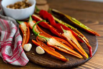 cut pods of red hot pepper on a wooden board