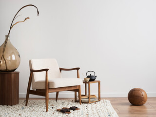 Interior design of aesthetic and minimalist living room with boucle armchair, wooden coffee table,...