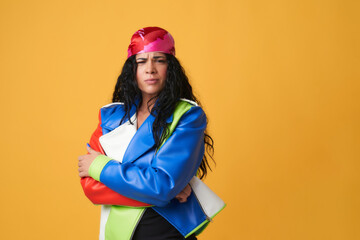 young woman with pink headscarf and colorful leather jacket with angry gesture