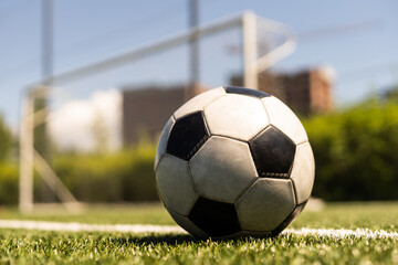 close-up view of leather soccer ball on green grass.