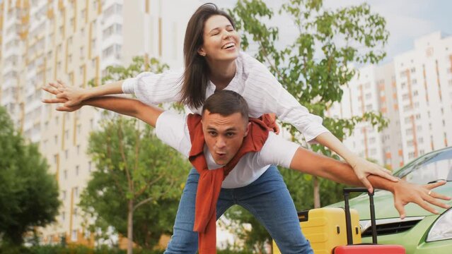 The guy swings to the sides of the girl sitting on his back and depicting a plane with her arms outstretched.