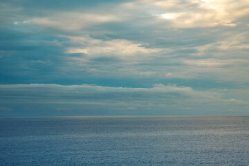 Fototapeta premium Calm sea with cloudy sky at sunset. Panorama of the Mediterranean sea in Liguria
