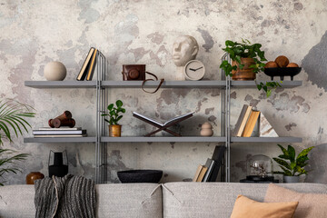 Loft style of modern living room with rack, books, plants, sofa and personal accessories. Gray concrete wall. Home decor. Template.