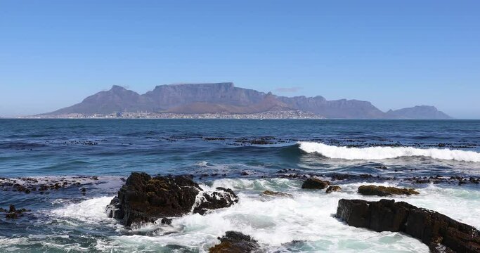 Looking across the Atlantic Ocean from Robben Island to  Cape Town city bowl with Table mountain. 