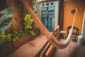 Small garden with chairs and hammock next to the house in Playa del Carmen, Mexico