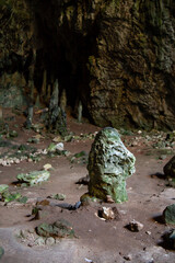 Obraz premium Stalactites stalagmites and streak formations in cave of Nimara Magarasi, Turkey. Stone walls and rocks in natural cave. stones covered with moss.