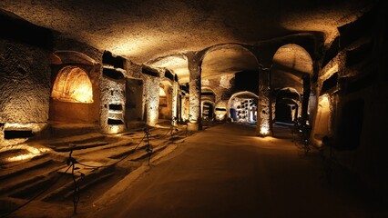 Tunnels of catacombs underground with burial holes - obrazy, fototapety, plakaty