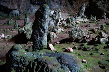 Stalactites stalagmites and streak formations in cave of Nimara Magarasi, Turkey. Stone walls and rocks in natural cave. stones covered with moss.