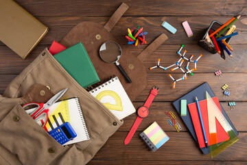 Back to school - books and school backpack on the desk in the auditorium, Education concept.