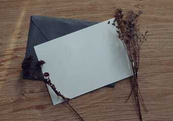 Mockup card with dried flowers. Invitation card with environment and details mockup with postcard and plants