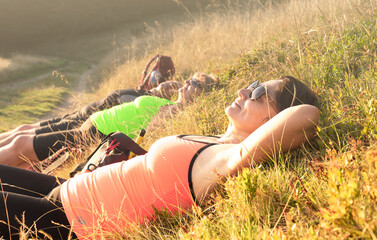 A happy woman in the mountains sleeps with pleasure and basks in the sun.