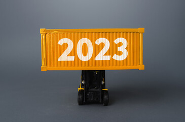Forklift with a shipping container with 2023. Analytics forecasting of freight traffic next year....