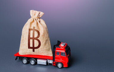 Truck with a thai baht money bag. High super income. Loan or deposit. Financial aid, investments and subsidies. Compensation. Payment of taxes. Debt. Cash collection. Money transfers and transactions.