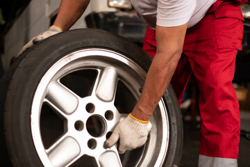 Concept car wheel service. Professional mechanic changing tires