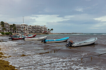 Fototapeta na wymiar Boats on the water, stormy sea in Playa del Carmen, Mexico