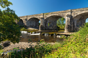Alston Arches, a disused viaduct on the River South Tyne at Haltwhistle during a dry summer in 2022