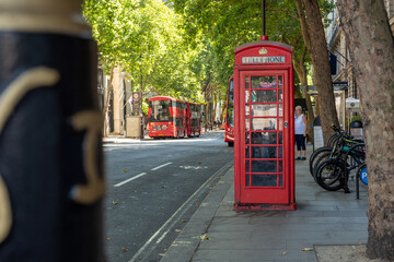 red phone booth in london in summer