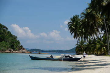 Indonesia Anambas Islands - Beach Scenery with palm trees and boats