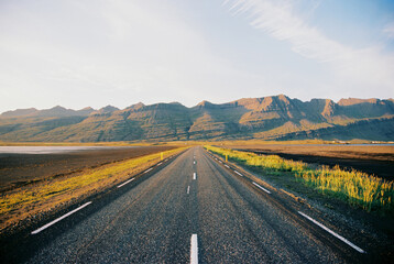 Asphalt road with mountain view in Iceland. Grainy film in the style of old photos. High quality photo