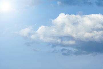 Sun in blue sky with white  clouds