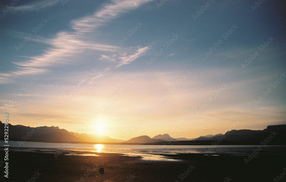 Wall mural sunset on a lake with mountain views in iceland. grainy film in the style of old photos. high qualit