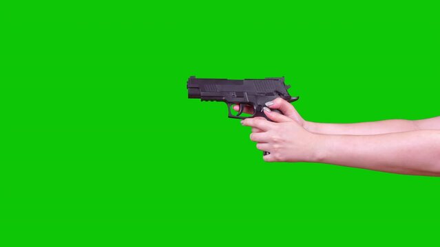 A Woman Holds A Pneumatic Pistol On A Green Screen In Her Hand