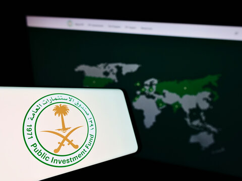 Stuttgart, Germany - 12-18-2021: Cellphone with logo of Saudi Arabian Public Investment Fund (PIF) on screen in front of business website. Focus on center-left of phone display.