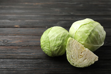 Ripe white cabbage on black wooden table
