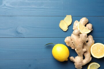 Fresh lemons and ginger on blue wooden table, flat lay. Space for text