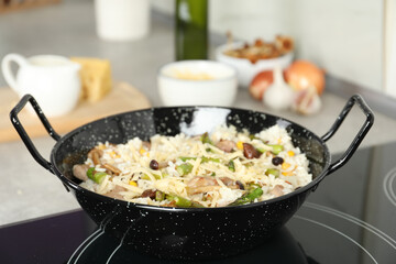 Delicious risotto in pan on induction stove