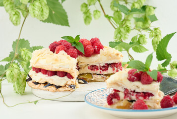 Round meringue pie with fresh raspberries on a white background, Pavlova dessert