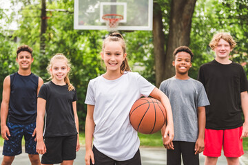 great child Team in sportswear playing basketball game
