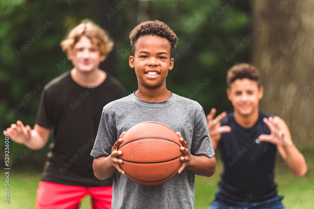 Wall mural great child team in sportswear playing basketball game