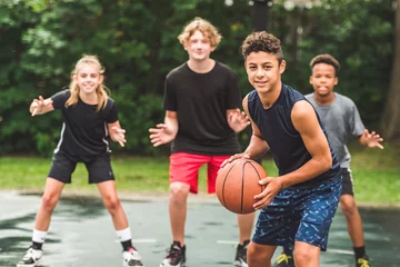 Foto auf Leinwand great child Team in sportswear playing basketball game © Louis-Photo