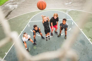 Gardinen great child Team in sportswear playing basketball game © Louis-Photo