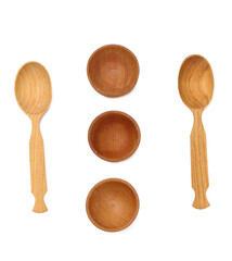 Empty wooden spoons and wooden bowls on a white isolated background