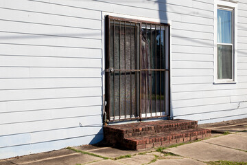 Old vintage historic white building side door with bars