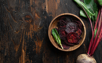 Dried beet chips on wooden background, top view, copy space