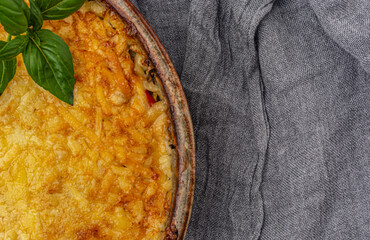 Lasagna with mozzarella and parmesan on a gray background