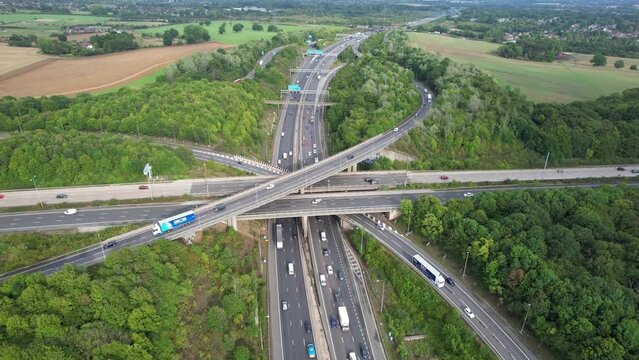 Aerial View of British Motorways With Fast Moving Traffic at Peak Time. M1 J11 and  J7 Motorways Junction Interchange. Time Lapse Shot captured on 7th Sep 2022