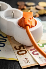 Electric plug, socket and euro money. Concept of increasing electric prices.