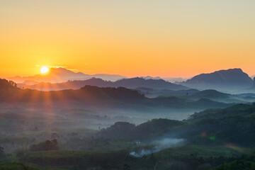 Mountain view with sunrise with little foggy