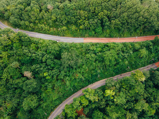 Aerial image winding mountain pass road through the forest - Travel Concept