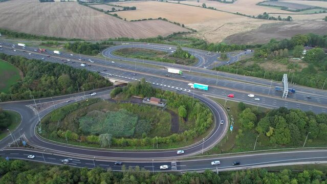 Aerial View of British Motorways With Fast Moving Traffic at Peak Time. M1 J11 and  J7 Motorways Junction Interchange. Time Lapse Shot captured on 7th Sep 2022