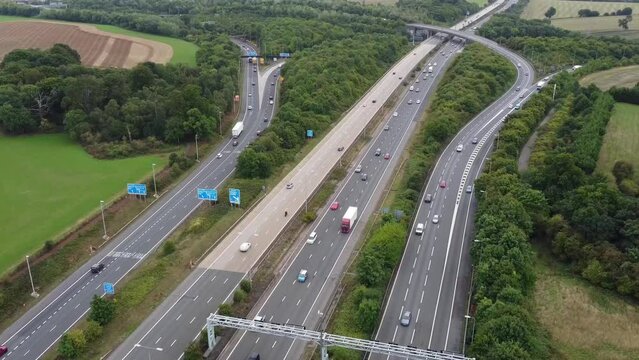 Aerial View of British Motorways With Fast Moving Traffic at Peak Time. M1 J11 and  J7 Motorways Junction Interchange. Time Lapse Shot captured on 7th Sep 2022