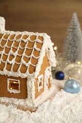 Beautiful gingerbread house decorated with icing on snow