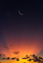 Crescent moon on dusk sky twilight vertical with orange sunlight after sundown © Nature Peaceful 