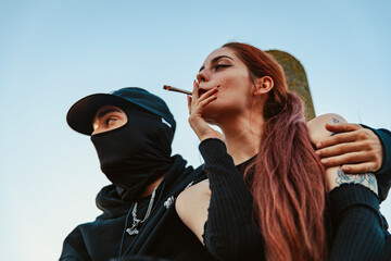 Young couple in love smoking a marijuana joint together