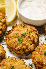 Close-up of crab cakes topped with fresh parsley